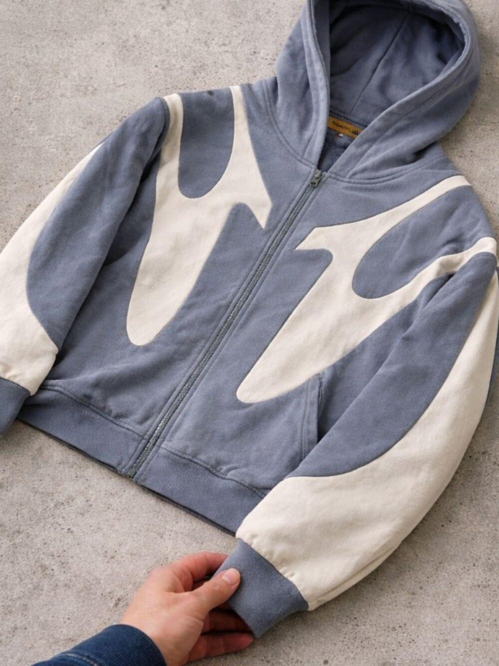 Stylish grey zip-up hoodie with standout design